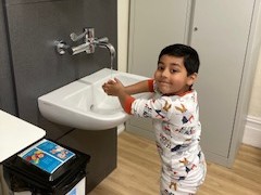 Photograph of child washing their hands