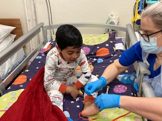 Photograph of hospital staff putting stick sensors on child
